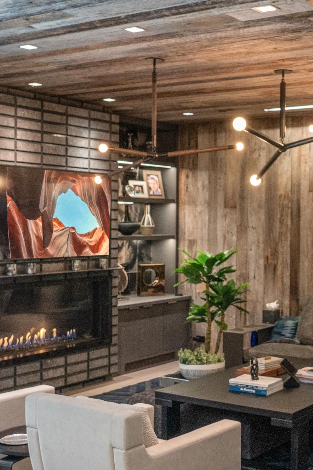 Living room with a fireplace TV shelves and modern lighting fixtures
